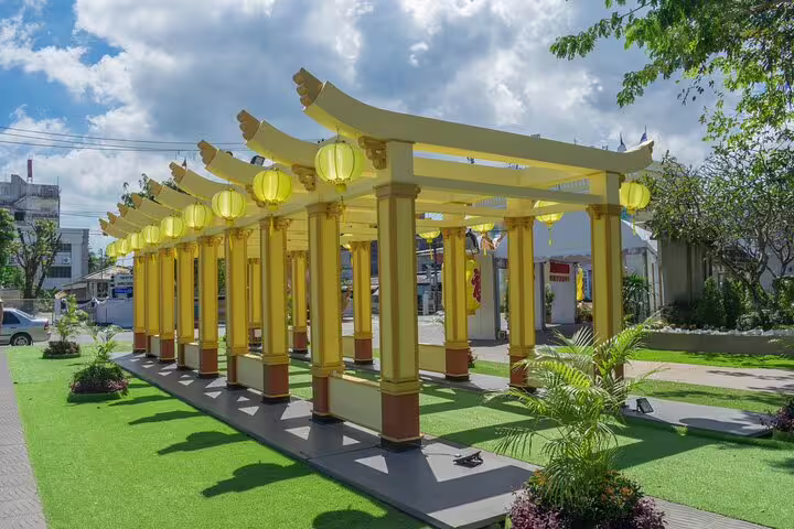 Yellow Chinese lantern pergola walkway with ornate columns in Bangkok Chinatown