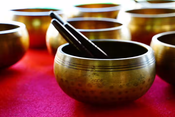 Tibetan singing bowls with mallets on red cloth, used in Bangkok old town cultural experiences