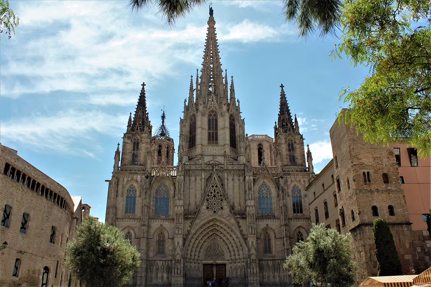 The stunning facade of Barcelona Cathedral in the Gothic Quarter under a clear blue sky.