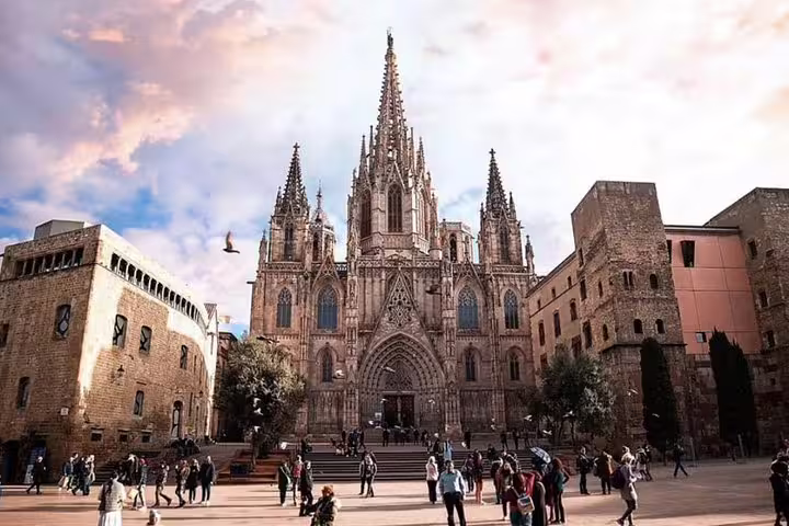 Tourists exploring Barcelona Cathedral's Gothic quarter on a private walking wine tasting and tapas dinner tour