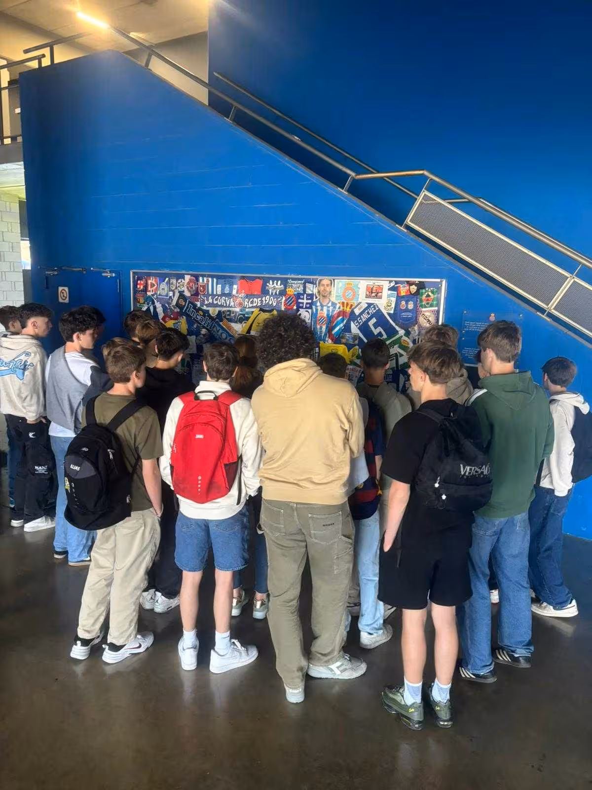 Fans gather by FC Barcelona memorabilia wall inside Camp Nou on Barcelona all-inclusive football tour
