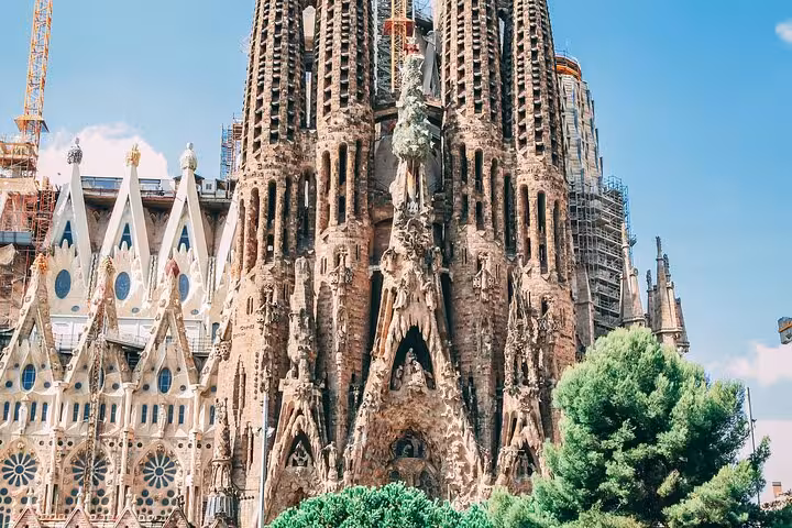 Sagrada Familia's detailed architecture against a bright sky, perfect for a full day car tour in Barcelona.