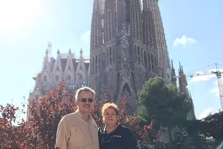 Tourists enjoying a sunny day at Sagrada Familia, a highlight of the Barcelona VIP Private Tour.