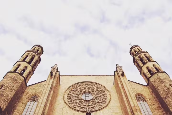 Gothic architecture of Santa Maria del Mar in Barcelona with detailed rose window and imposing twin towers.