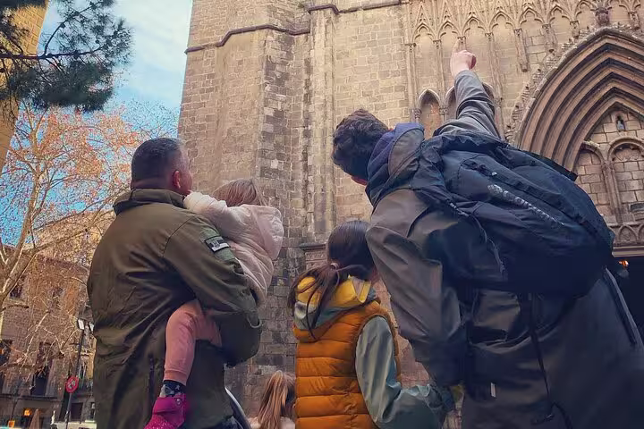 Family exploring Barcelona's Gothic Cathedral with a guide on a private walking tour.