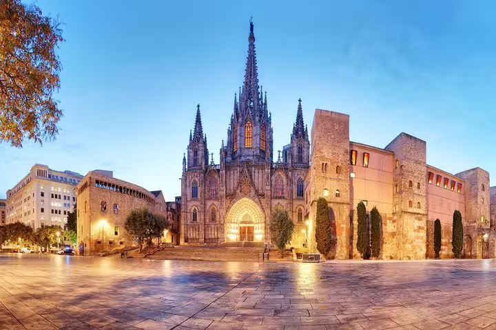 Stunning view of Barcelona's Gothic Quarter at dusk, featuring the illuminated Barcelona Cathedral's intricate architecture.