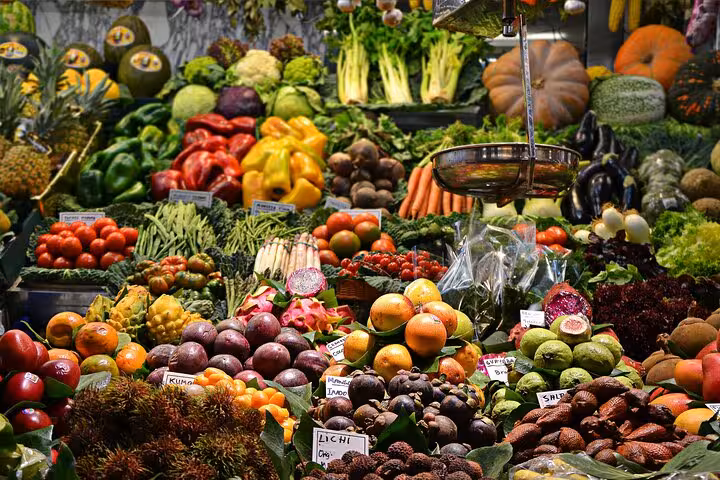 Colorful fruit and vegetable stalls at La Boqueria, highlight stop on Barcelona private small group food tour