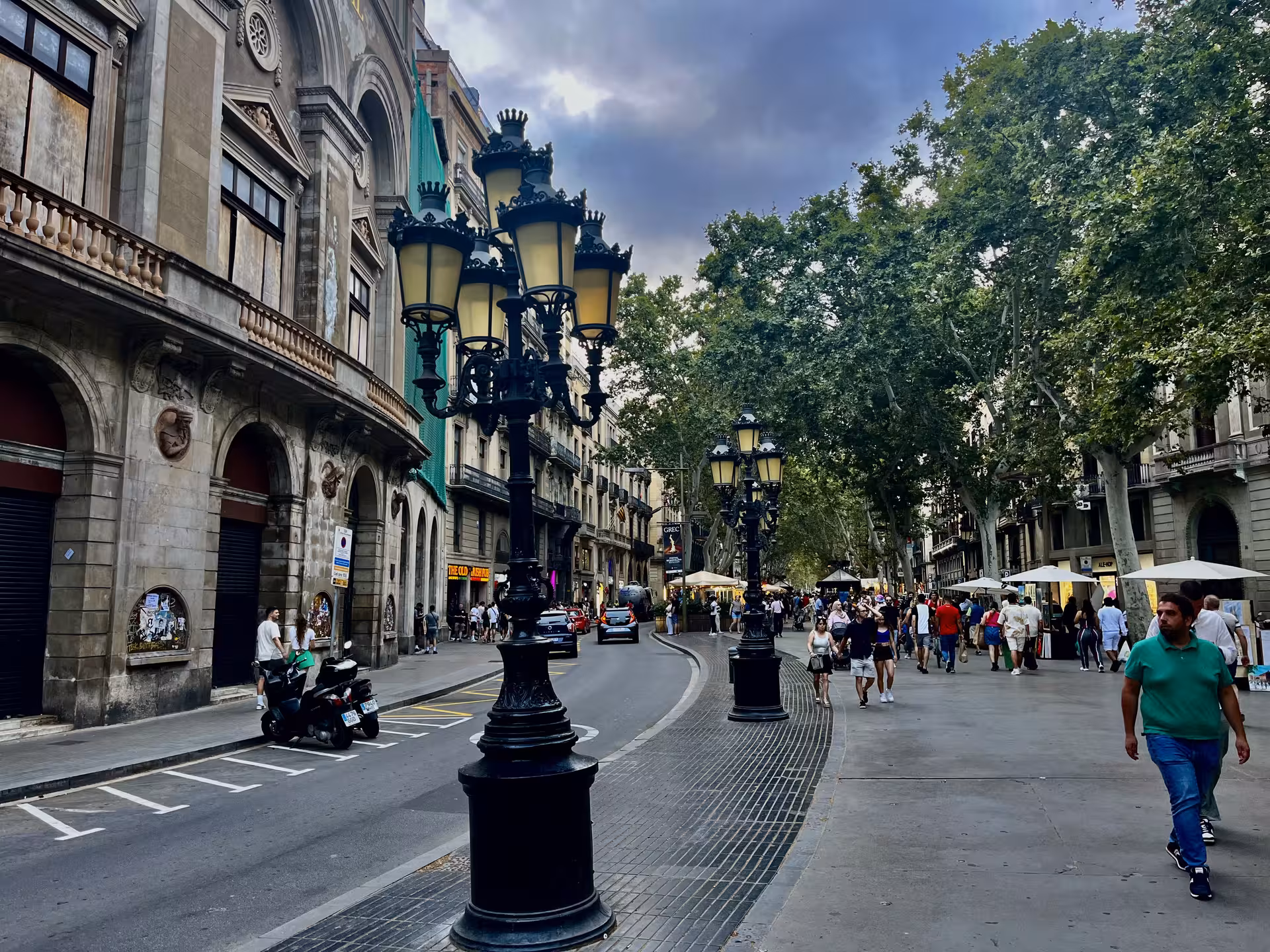 Stroll down La Rambla in Barcelona on Misterios Locales tour, near Museo de Cera and historic street lamps