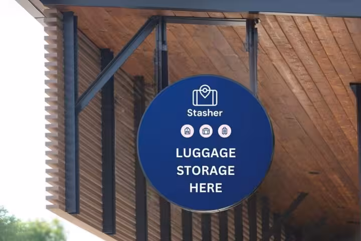 Blue Stasher sign reading luggage storage here at a Barcelona left luggage point near transport and attractions
