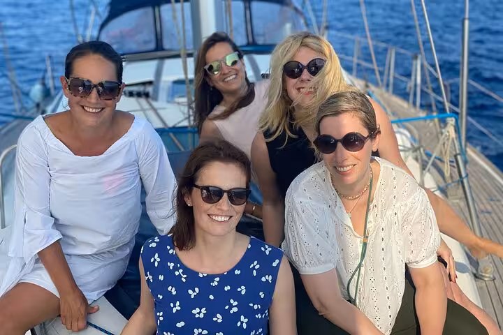 Women relaxing on deck during a Barcelona private luxury sailing tour, enjoying Mediterranean sea views
