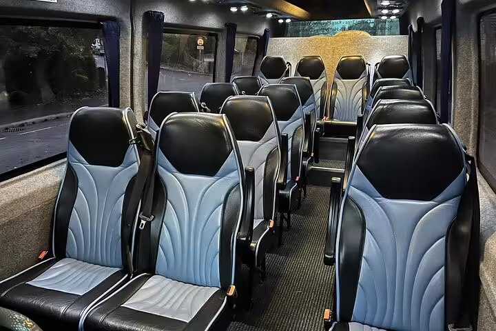Luxury private minibus interior with blue and black leather seats for Barcelona to Madrid transfer