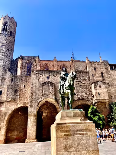Statue of a horseman in front of the Gothic architecture of the Barcelona Cathedral, highlighting Ribera's medieval heritage.
