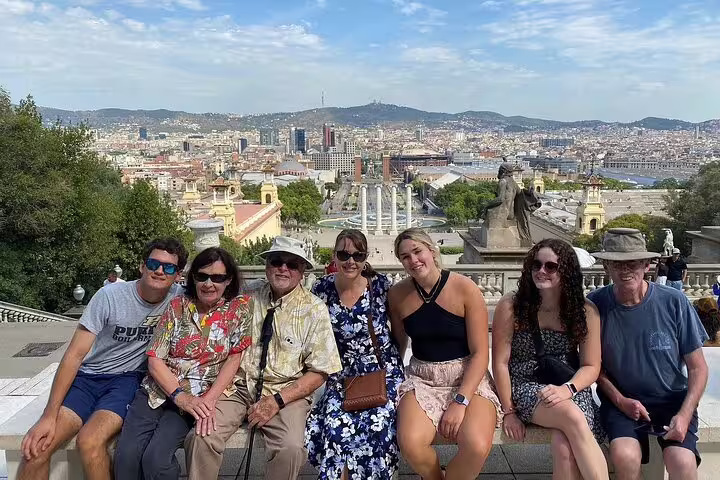 Group of tourists enjoying breathtaking views over Barcelona from Montjuic, capturing the essence of a premium city tour.