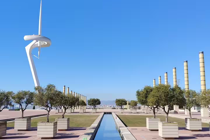Panoramic view of Montjuïc Communications Tower and landscaped gardens, part of Barcelona private tours.