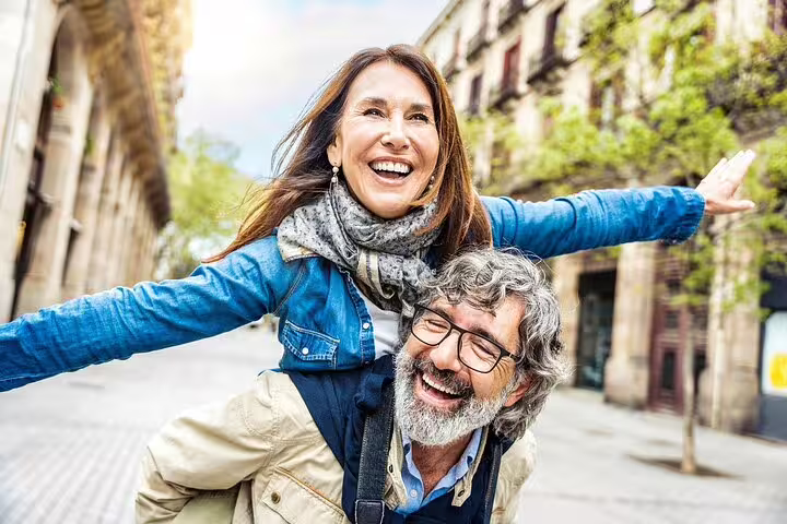 Couple joyfully exploring Barcelona streets on a guided tour with Montserrat highlights, featuring convenient hotel pick-up.