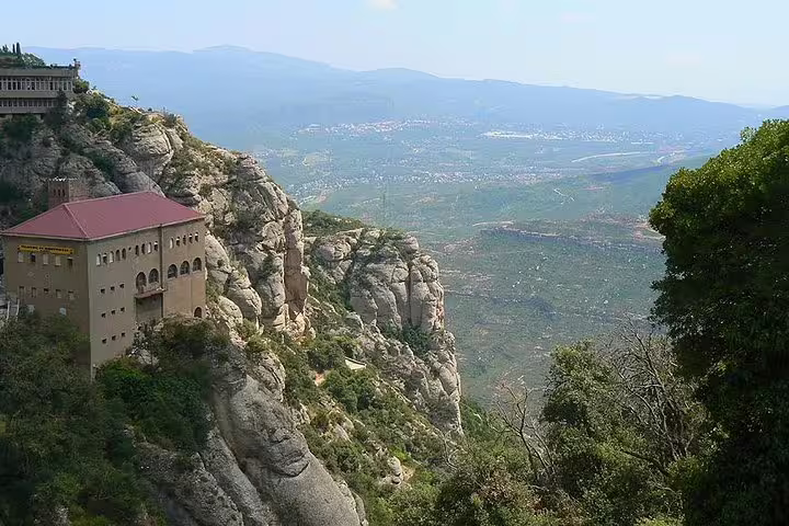 Scenic view of Montserrat mountain landscape with historic monastery, ideal for Barcelona Highlights tour with hotel pickup.