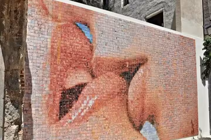 Vibrant mosaic mural in Barcelona, a highlight on the immersive walking tour of top city sights.