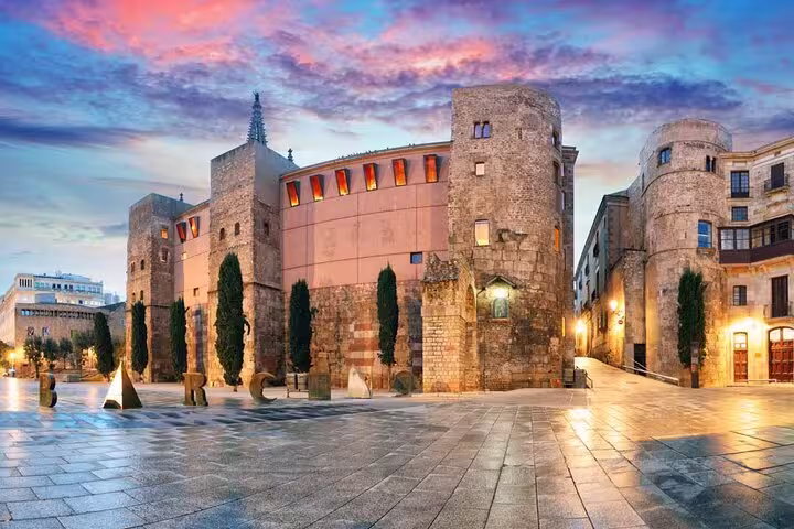 Historic stone buildings under vibrant sunset skies on a private Old Town tour with optional zoo and aquarium tickets.