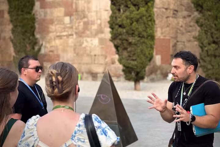 Tour guide passionately explains a historic landmark to visitors in Old Town on a private tour.