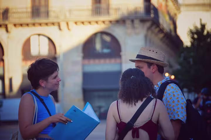 Tour guide engages with visitors in the historic old town, highlighting the 1.5h Private Old Town Tour experience.