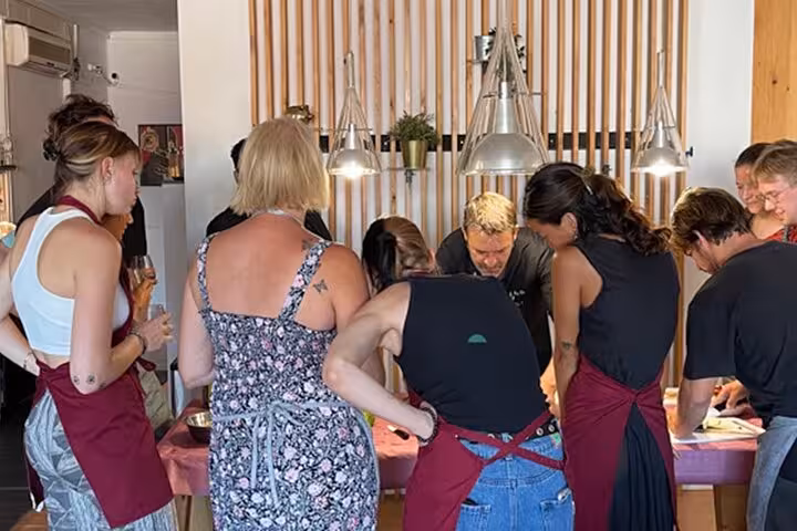 Participants engaged in hands-on cooking class, learning to prepare traditional Spanish dishes in Barcelona.