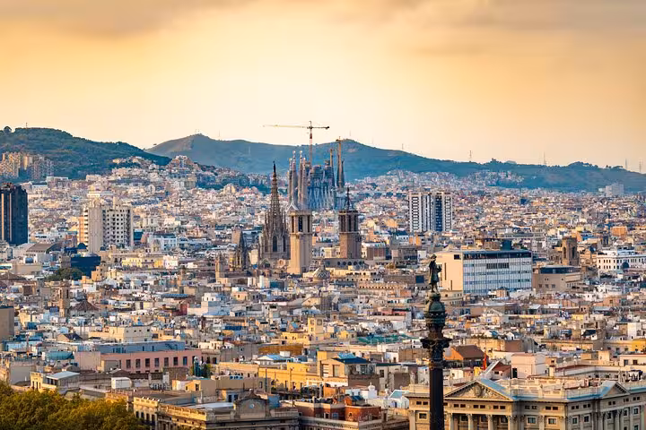 Panoramic Barcelona skyline with Sagrada Familia at sunset, seen on a full-day private vehicle city tour