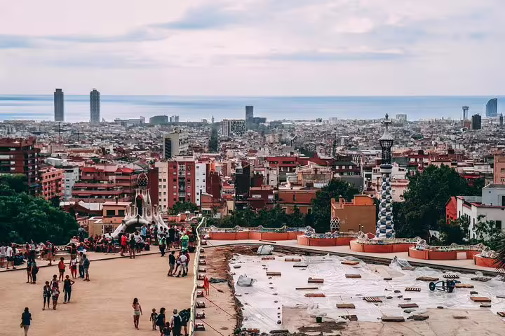 Panoramic view of Barcelona from Park Güell showcasing the cityscape and vibrant tourist activity.