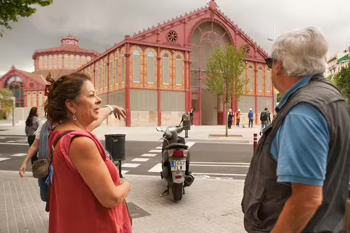 Tourists explore the vibrant architecture of the Mercat de Sant Antoni in Barcelona's Raval Quarter on a private walking tour.