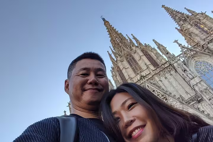 Visitors smile with the iconic spires of Barcelona's Sagrada Familia in the backdrop during a VIP private tour.