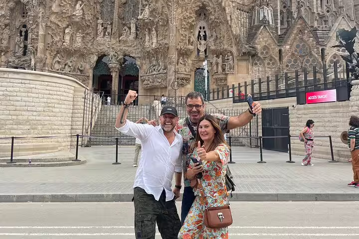 Group celebrating outside Sagrada Familia on a Barcelona scavenger hunt and sights self-guided tour