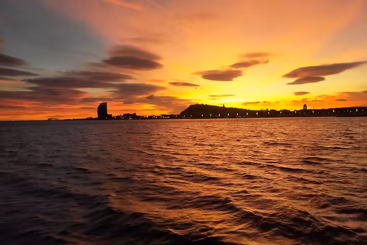 Barcelona sunset sailing tour with skyline views from the sea, perfect for private cruise with open bar