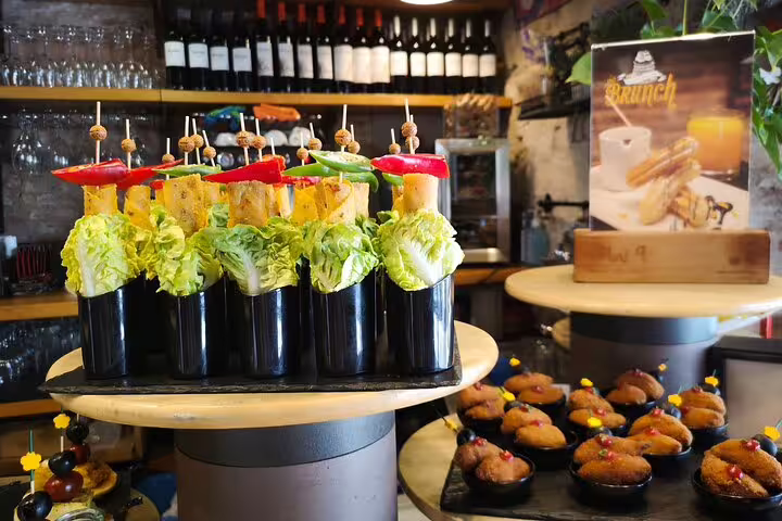 Colorful tapas display with fresh vegetables and skewers, set in a cozy Barcelona venue, perfect for a wine and flamenco tour.