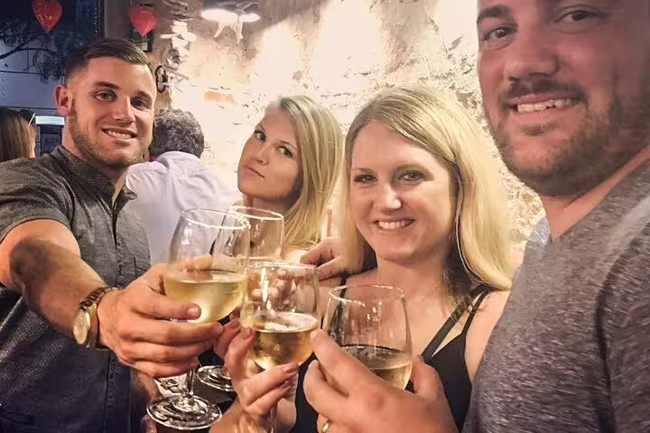 Group of friends enjoying wine and tapas on a vibrant Barcelona tour, capturing the essence of Spanish culture and flamenco spirit.