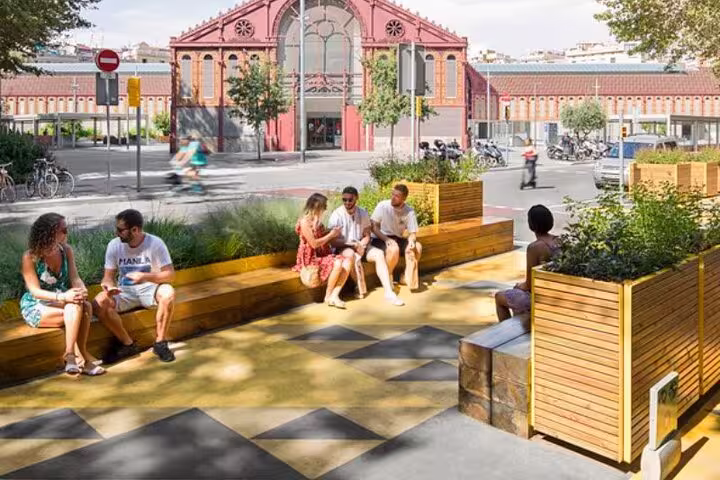 People relaxing in a vibrant urban parklet in Barcelona, illustrating community-friendly spaces on the sustainable city tour.