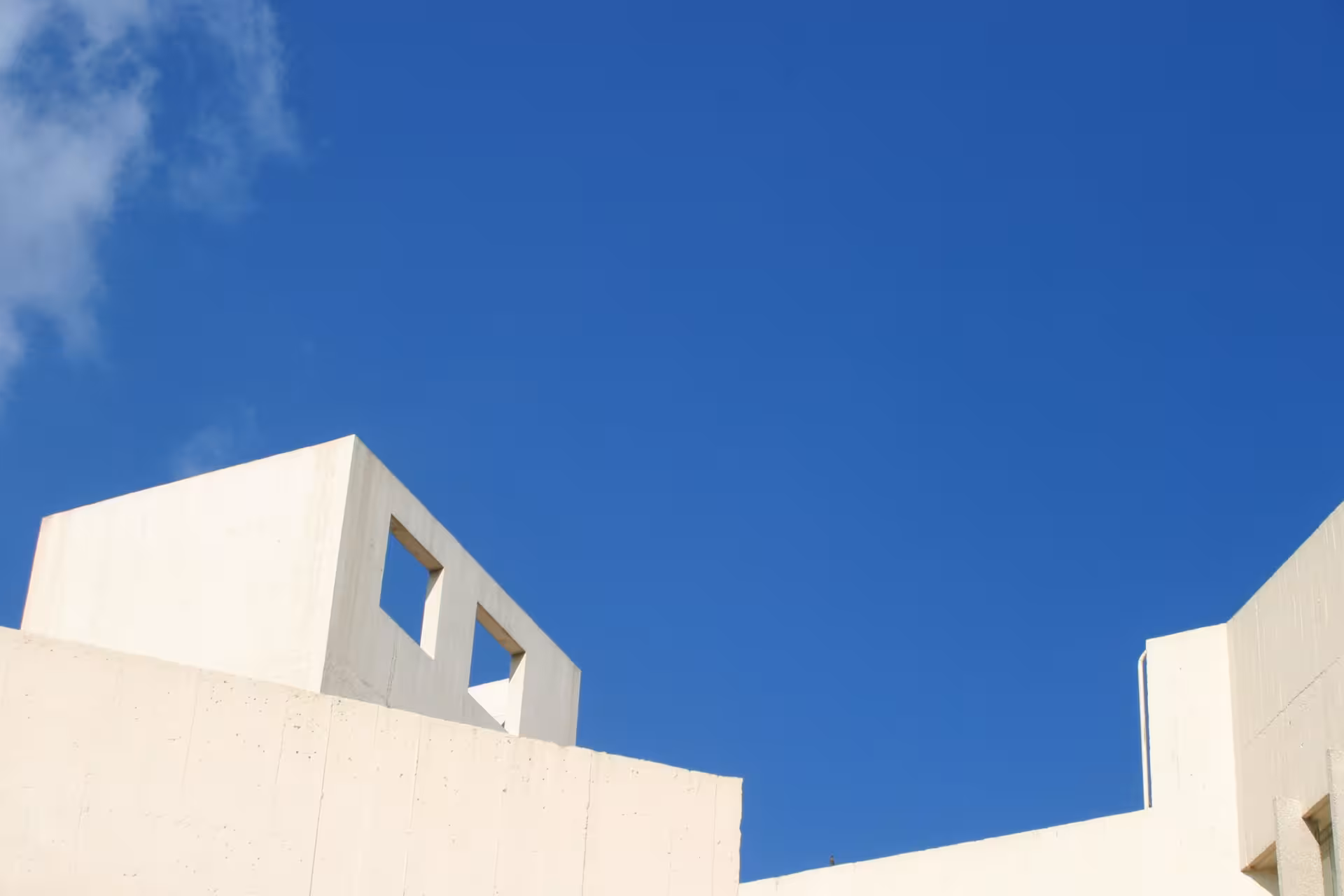 Modern white architecture against blue sky on a Half-Day Barcelona panoramic city tour by private vehicle