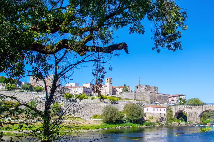 Scenic view of Barcelos' historic architecture and bridge along the river, perfect for a private half-day tour from Porto.