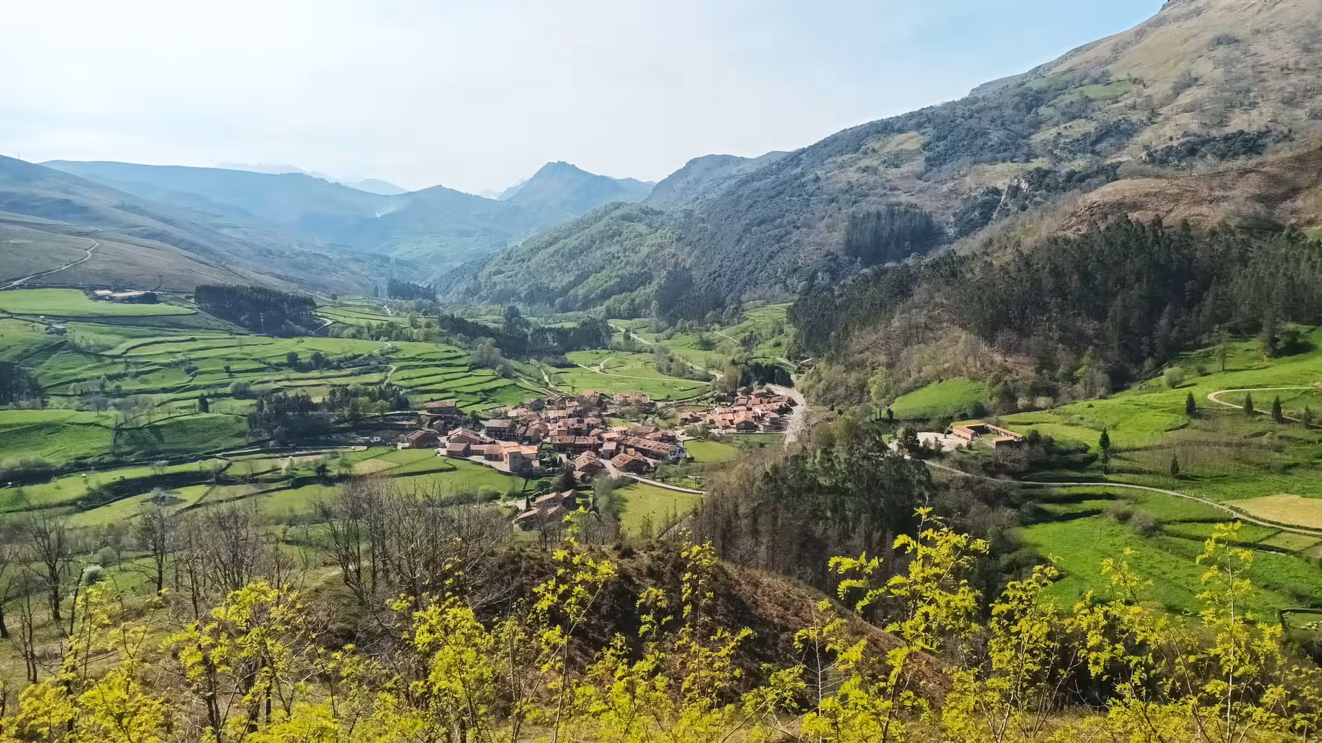 Panoramic view of Bárcena Mayor village nestled in a green valley surrounded by mountains in Cantabria Spain