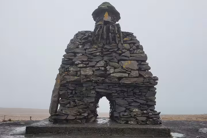 Iconic Bardur Snaefellsas stone sculpture on misty Snaefellsnes Peninsula private day trip from Reykjavik