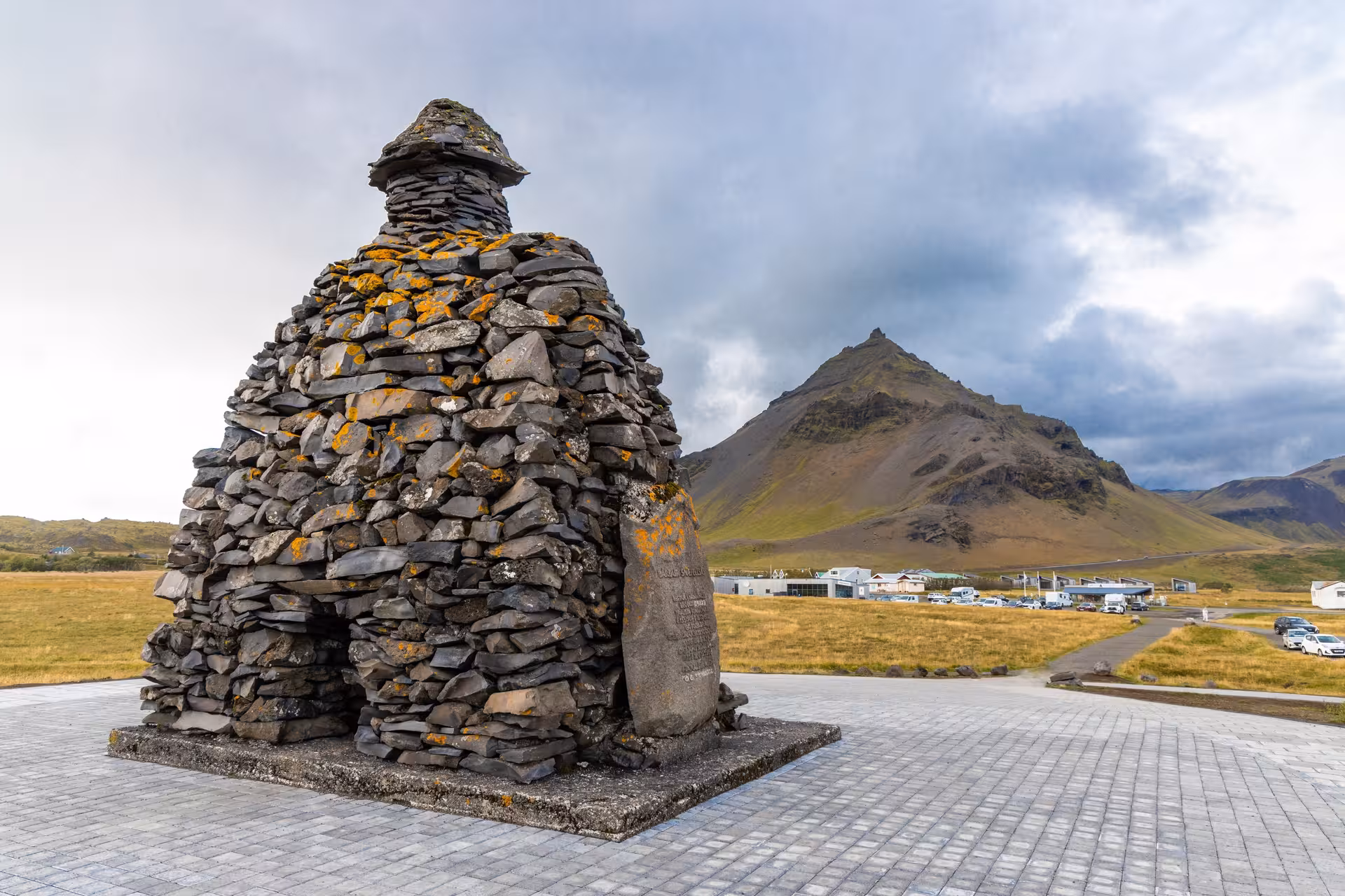 Stone figure sculpture of Bardur Snaefellsas with pointed Stapafell mountain in background, Snaefellsnes Peninsula Iceland