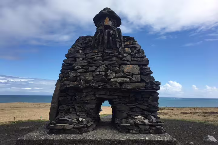 Stone troll sculpture Bárður Snæfellsás on Snaefellsnes Peninsula with ocean backdrop