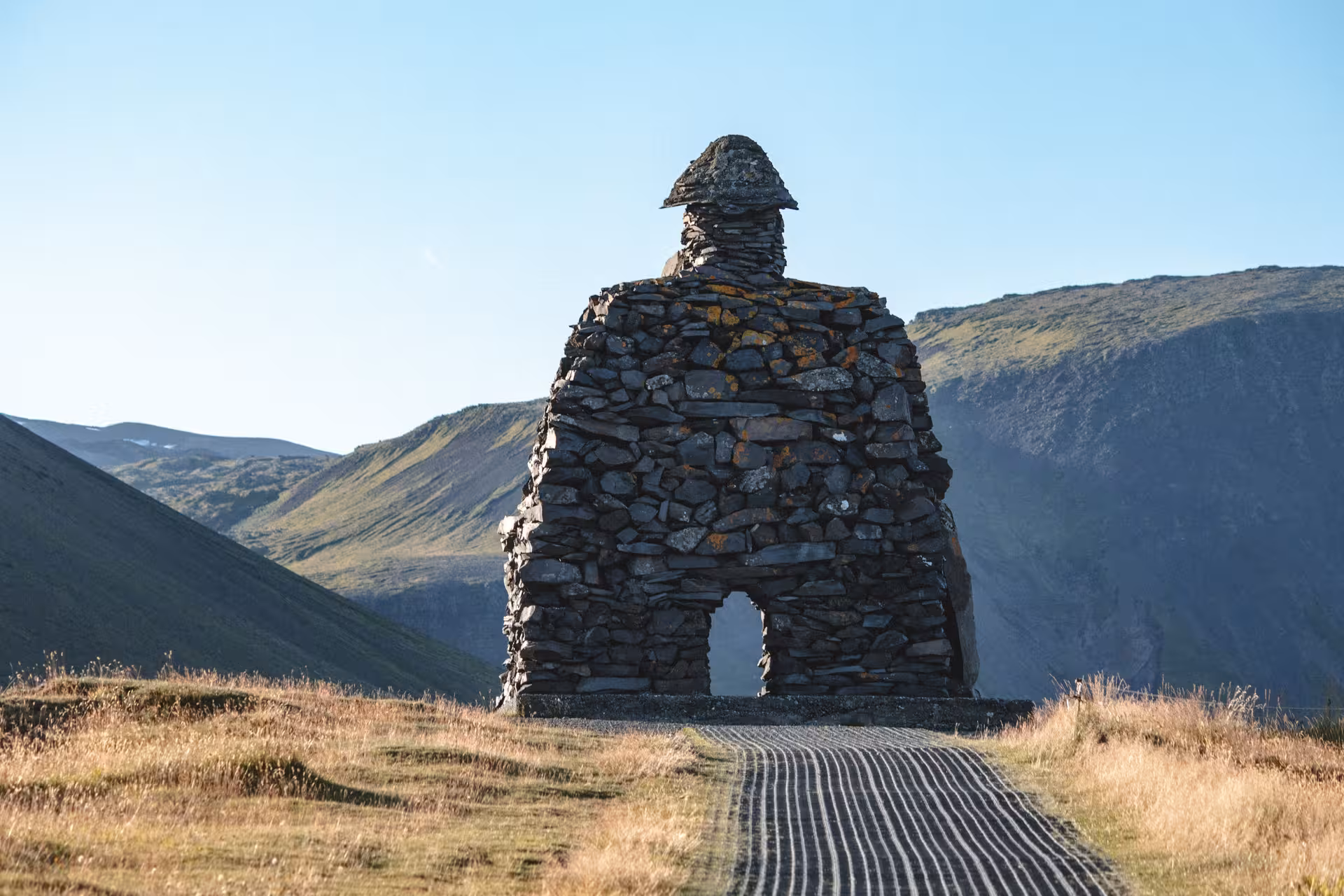 Stone troll sculpture Bárður Snæfellsás standing in Icelandic mountain valley on Snæfellsnes Peninsula