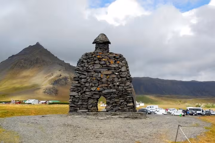 Stone giant sculpture Bardur Snaefellsas with volcanic mountain backdrop on Snaefellsnes Peninsula Iceland