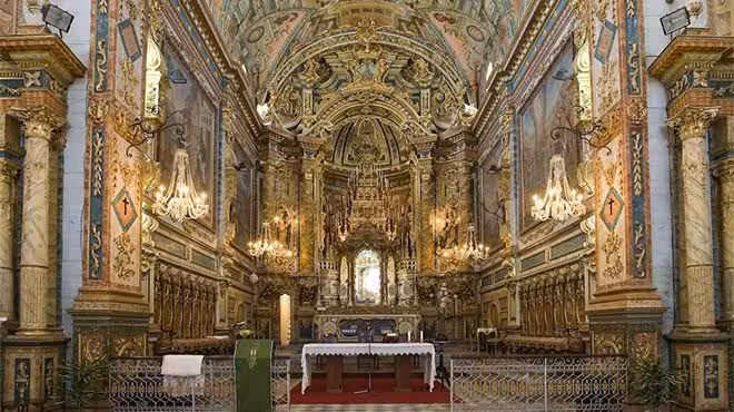 Baroque gold‑leaf altar and ornate chandeliers inside historic church in Tavira, Algarve, on The Secrets of the Leeward Islands tour
