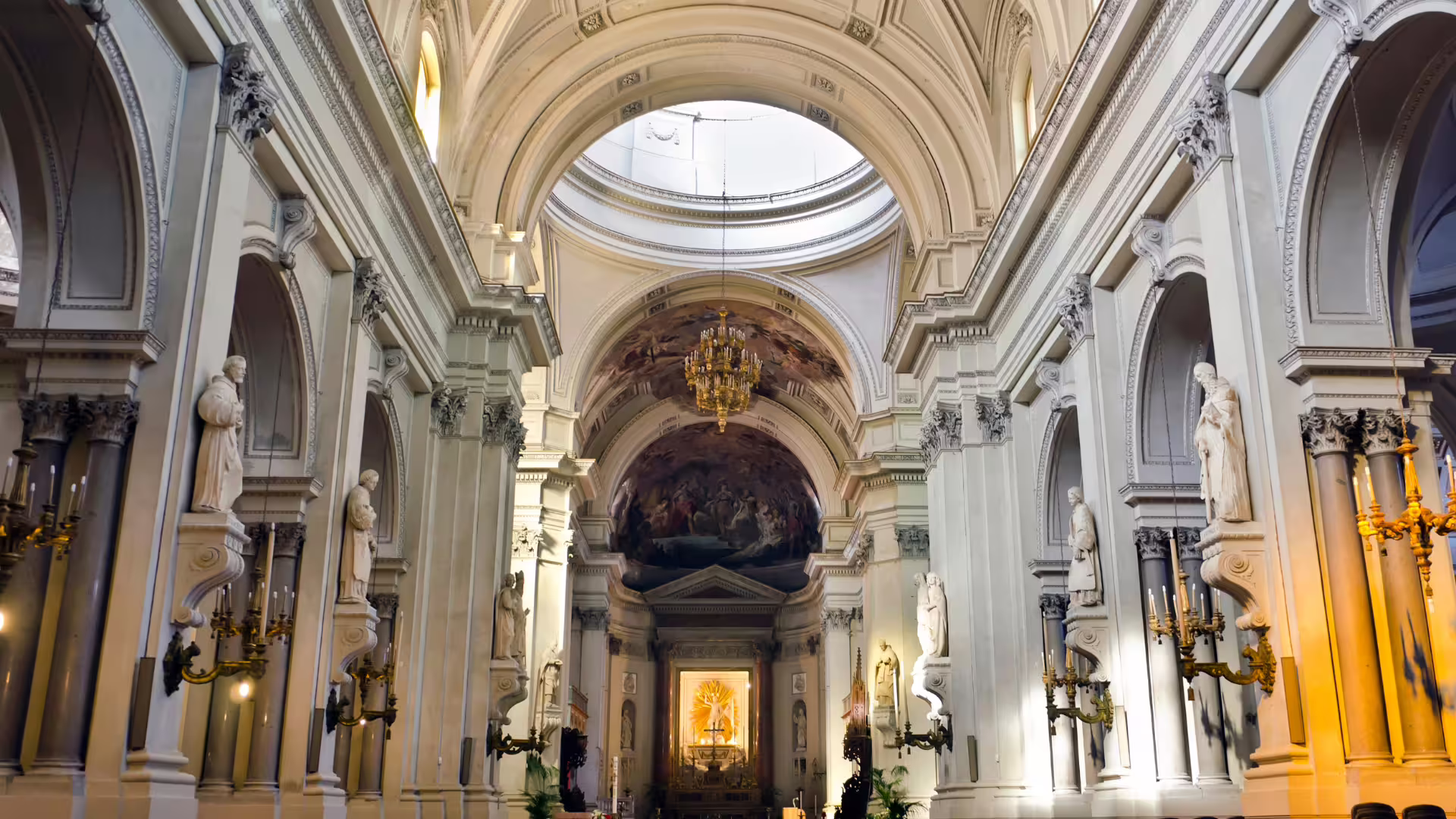 Baroque interior of Palermo cathedral on private Monreale and Mondello tour, with statues, arches and golden altar glowing