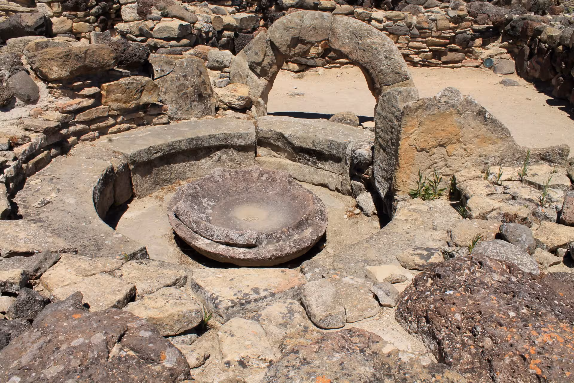 Discover the ancient stone ruins and circular structures at the Barumini archaeological site in Sardinia.