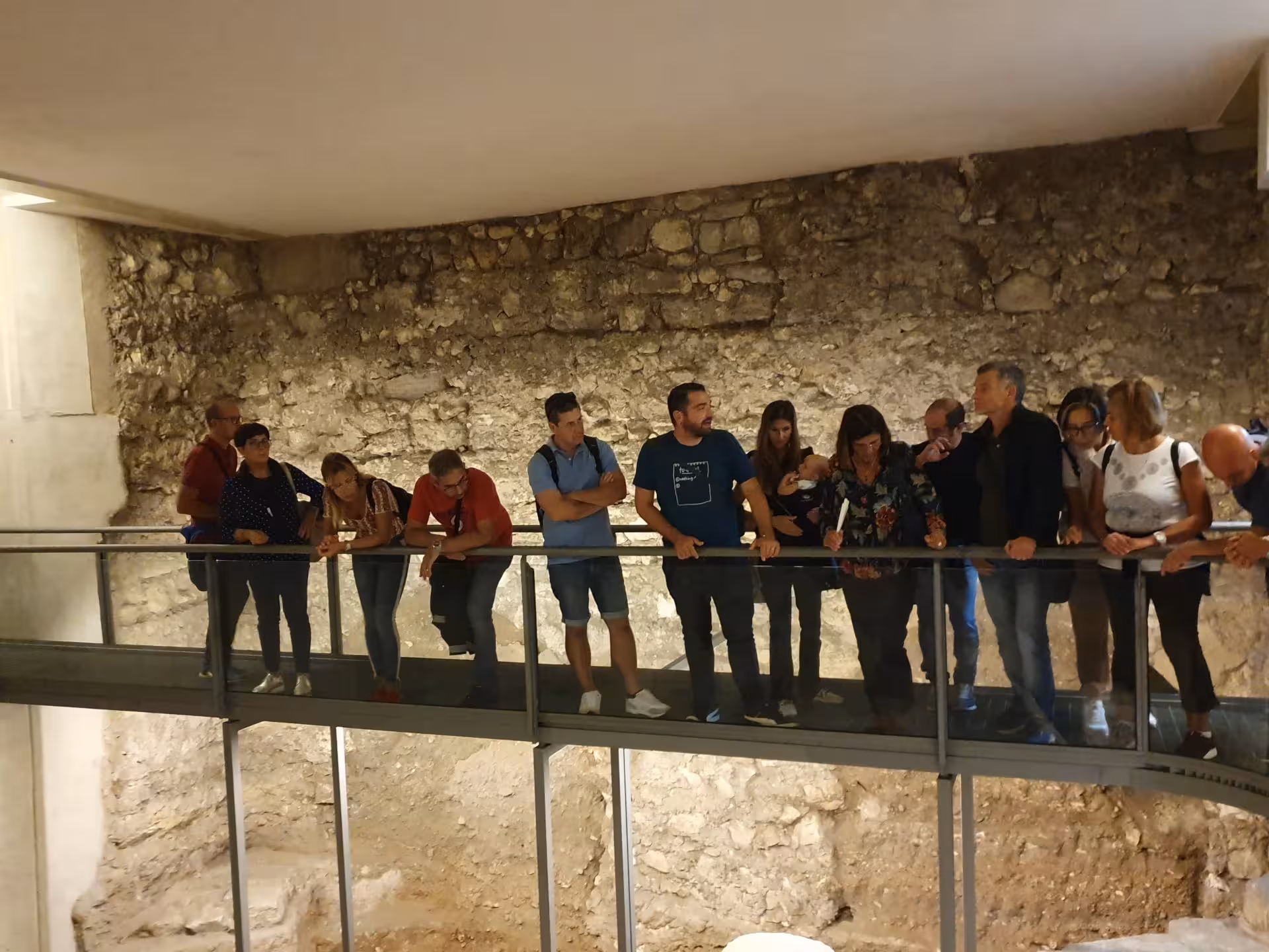 Tourists exploring the ancient stone ruins at Barumini UNESCO site on a guided trip from Cagliari.