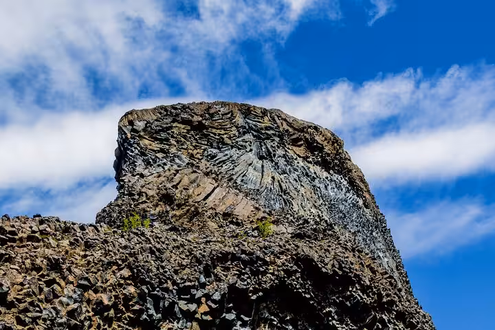 Stunning basalt rock formation under a clear blue sky on the 4x4 Diamond Circle Day Tour in Iceland.