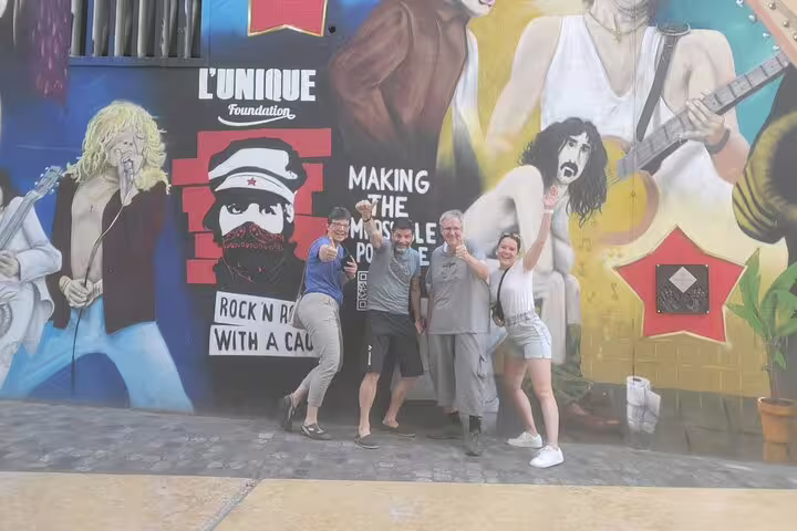 Group poses in front of vibrant mural on Basel scavenger hunt and sights self-guided walking tour in Switzerland