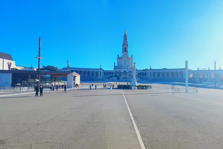 The stunning Basilica of Our Lady of Fátima stands majestically under a clear blue sky, inviting visitors to explore its spiritual significance.