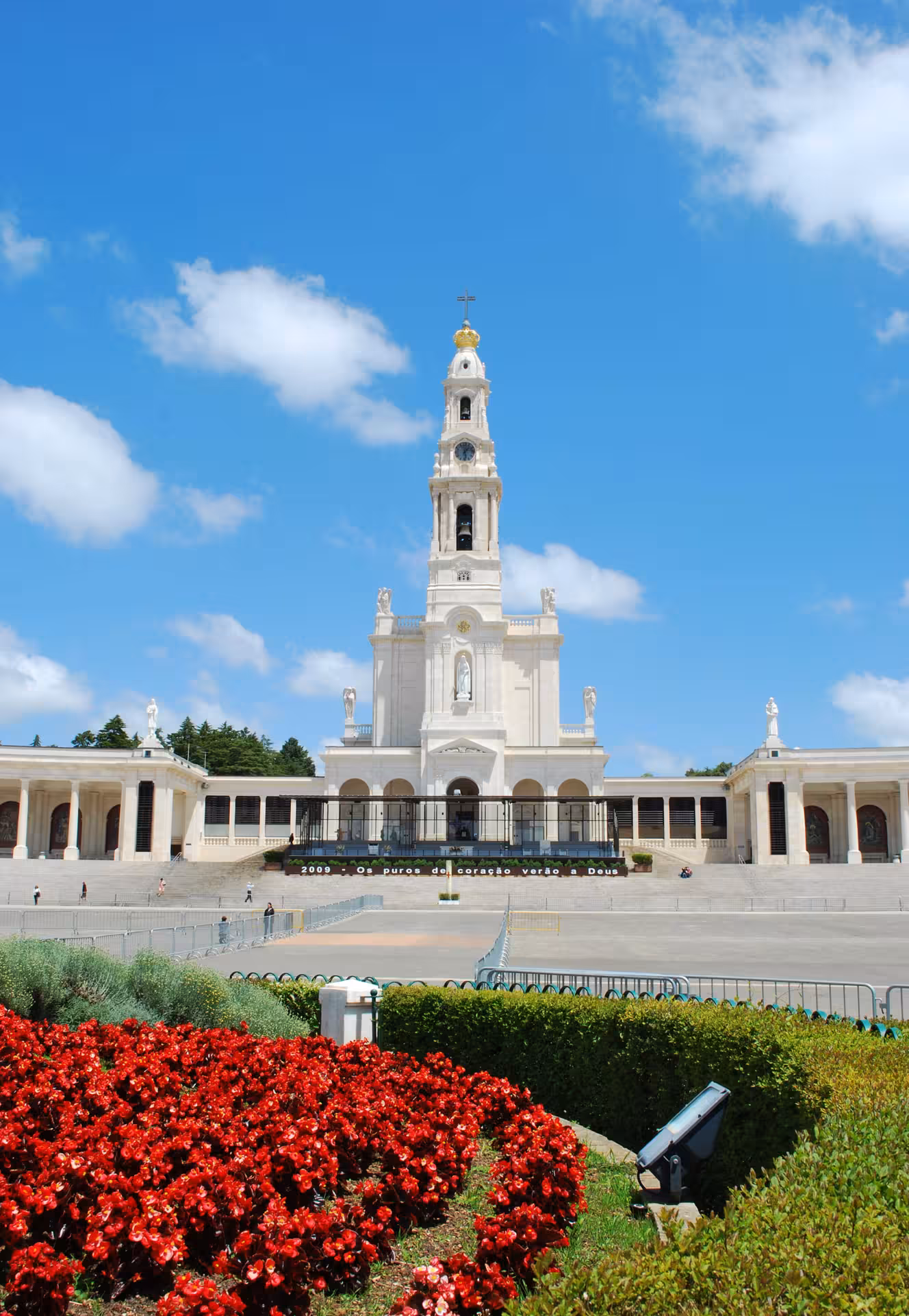 Beautiful Basilica of Our Lady of the Rosary in Fátima, surrounded by vibrant gardens, on the full-day tour itinerary.